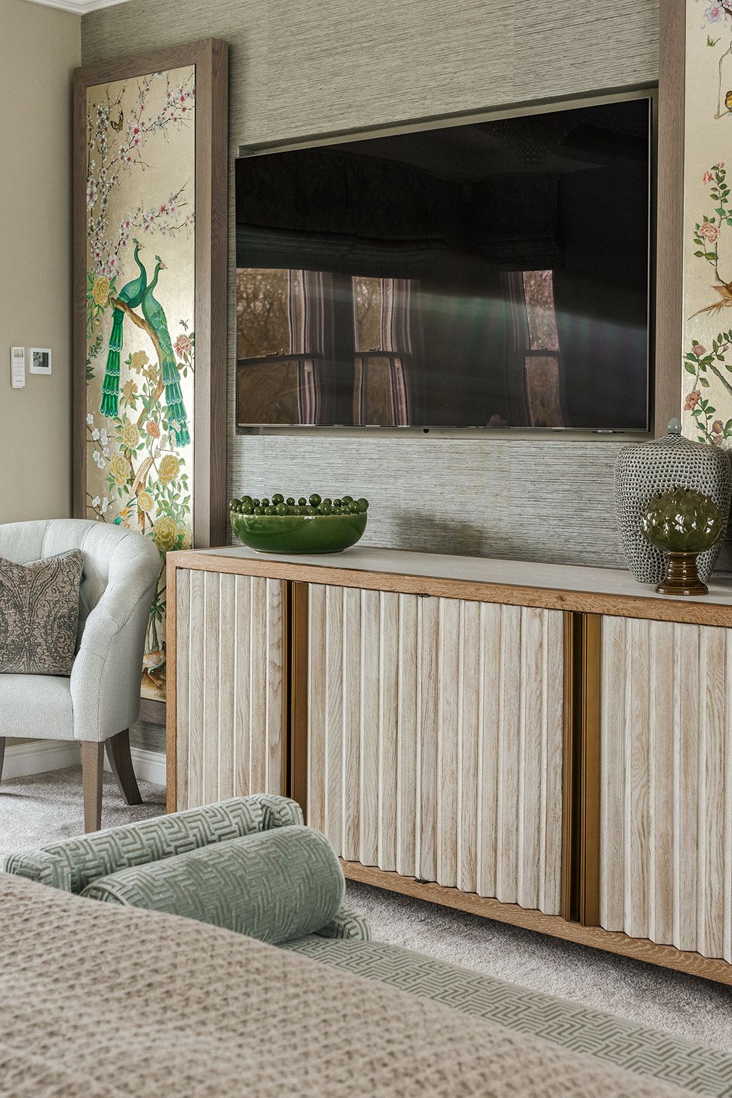 Bespoke fluted media unit with chinoiserie art panels